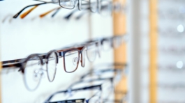 in optician shop- glasses for sale in wall rack