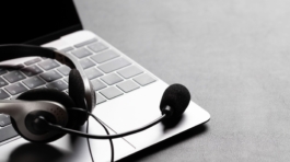 Office desk with headset and laptop. Remote office and work from home concept. With copy space